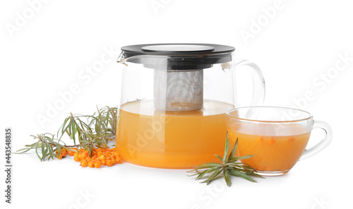 Teapot of healthy sea buckthorn tea on white background