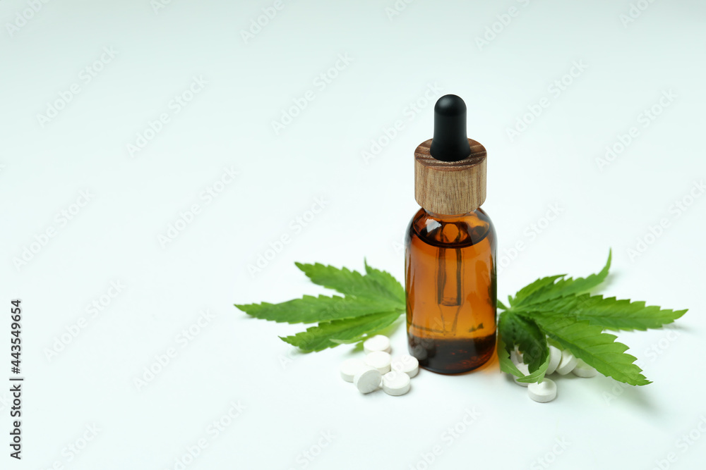 Cannabis leaves, pills and oil on white background Cannabis leaves, pills and oil on white background