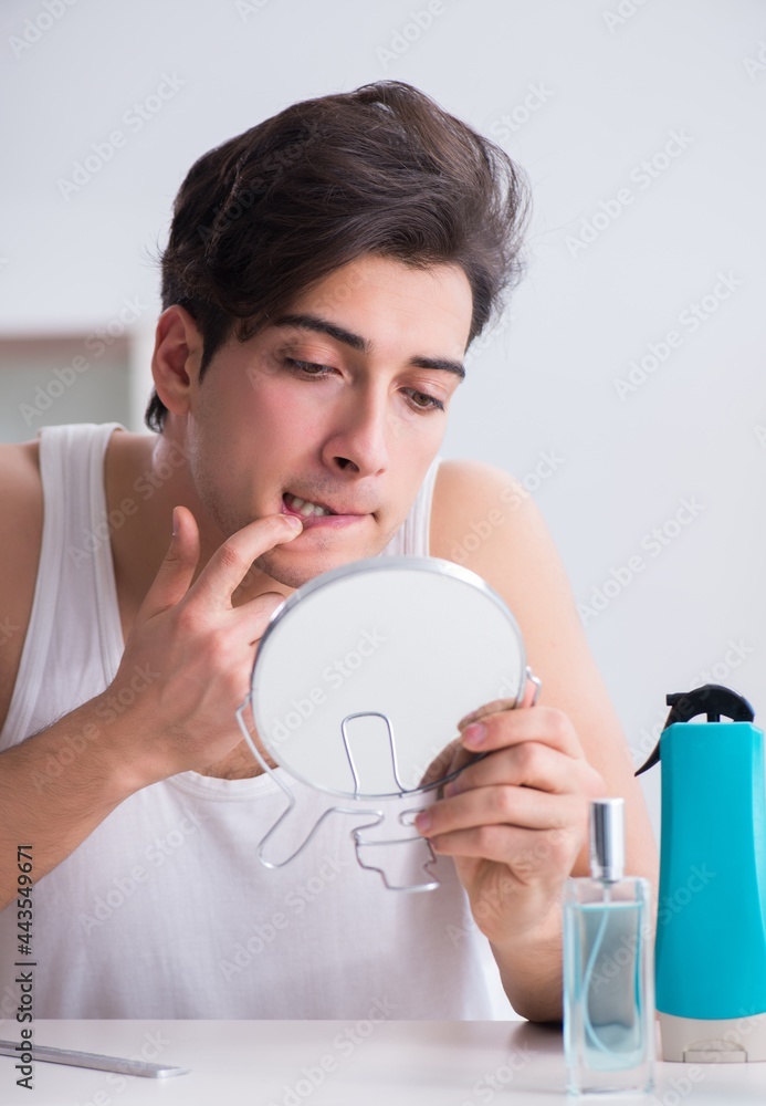 Young handsome man staring in the mirror Young handsome man staring in the mirror