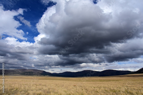 dramatic clouds over the  mountain meadow at valles caldera national preserve, near los alamos, new mexico photo