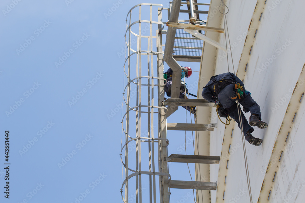 Male two worker rope access  inspection of thickness storage tank industry
