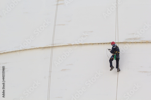 Male worker rope access inspection of thickness storage tank industry