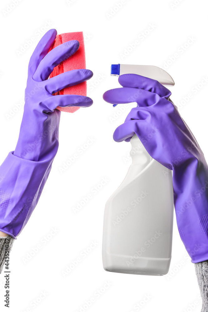 Woman spraying detergent onto cleaning sponge on white background