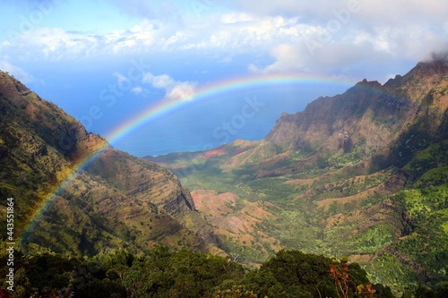 stunning rainbow over the kalalau valley, as seen from the pu'u o kila overlook in kauai, hawaii 