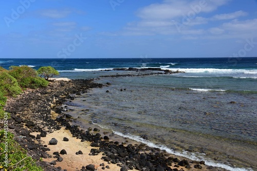 pretty beach and  coastline on a sunny day along the kauai path, north of kapa'a, kauai, hawaii photo