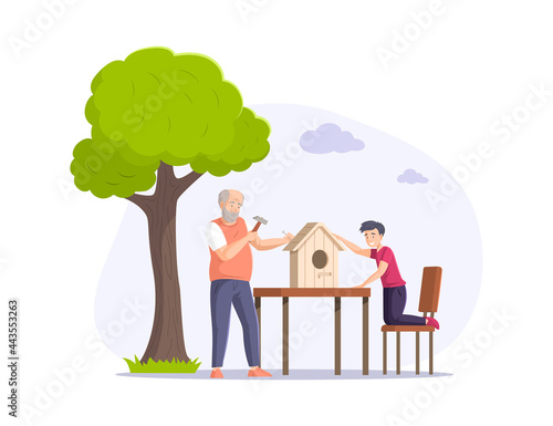 Grandfather and grandson making birdhouse together. Happy family building wooden house for birds