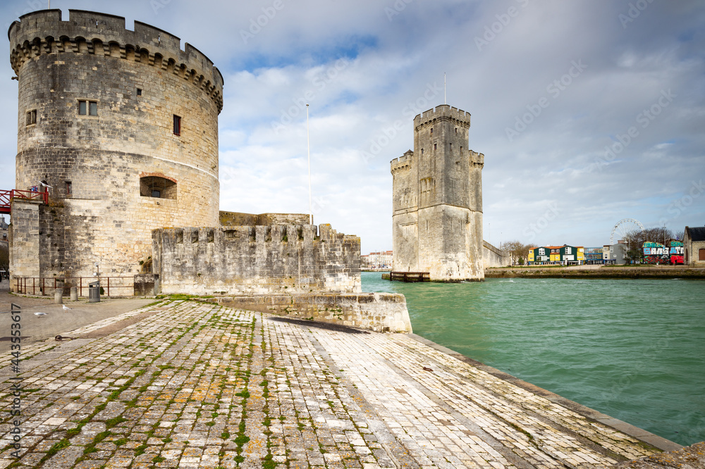 Entrance of the old harbor of La Rochelle in France, with the Tour de la Chaine and Tour Saint-Nicolas, Nouvelle Aquitaine region, department of Charente-Maritime. France