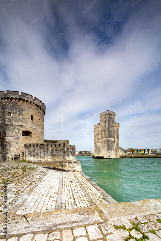 Entrance of the old harbor of La Rochelle in France, with the Tour de la Chaine on the left and Tour Saint-Nicolas on the right, Nouvelle Aquitaine region, department of Charente-Maritime, France.