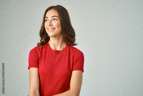 cheerful woman in red t-shirt fashion glamor lifestyle light background