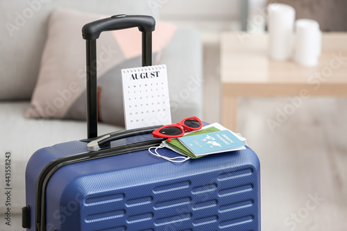 Packed suitcase with calend...