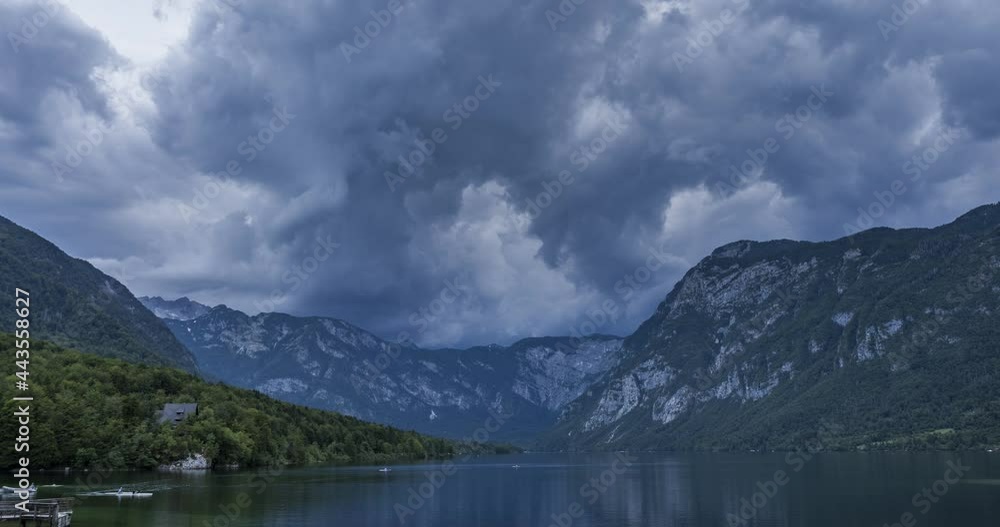 Time lapse of dramatic clouds forming in the sky over glacial lake Bohinj, Slovenia. Storm clouds in the Alps. Beautiful and amazing nature in mountains. Zoom out, wide angle Time lapse of dramatic clouds forming in the sky over glacial lake Bohinj, Slovenia. Storm clouds in the Alps. Beautiful and amazing nature in mountains. Zoom out, wide angle