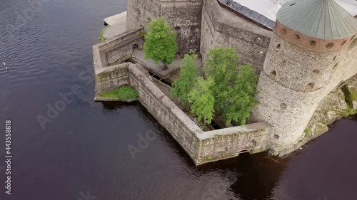 Aerial view of stone walls of the medieval castle Olavinlinna by calm lake