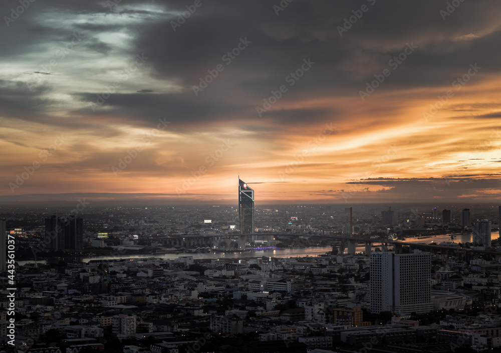 Bangkok, thailand - Jul  02, 2021 : Aerial view of Beautiful sunset over large metropol city in Asia. There are prominent and isolated high-rise buildings along the Chao Phraya River. Monotone.
