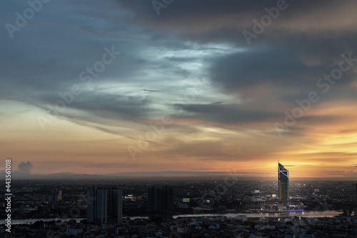 Bangkok, thailand - Jul 02, 2021 : Aerial view of Beautiful sunset over large metropol city in Asia. There are prominent and isolated high-rise buildings along the Chao Phraya River. Selective focus.