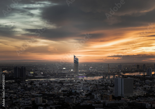 Bangkok, thailand - Jul 02, 2021 : Aerial view of Beautiful sunset over large metropol city in Asia. There are prominent and isolated high-rise buildings along the Chao Phraya River. Monotone.