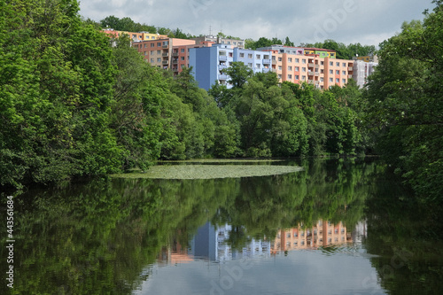 Pastel apartment buildings behind idyllic lake, Egerland, Czechoslovakia
 photo