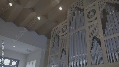 Camera panning along a large wooden organ in a church photo