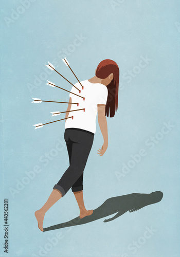 Dejected woman walking with arrows in back
 photo
