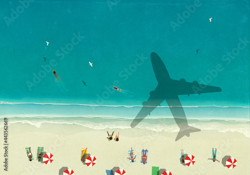 Aerial view shadow of airplane flying over tourists on sunny ocean beach
 photo