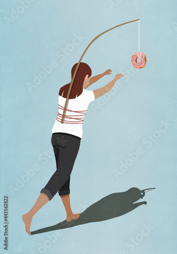 Woman chasing donut tied to stick on back
 photo