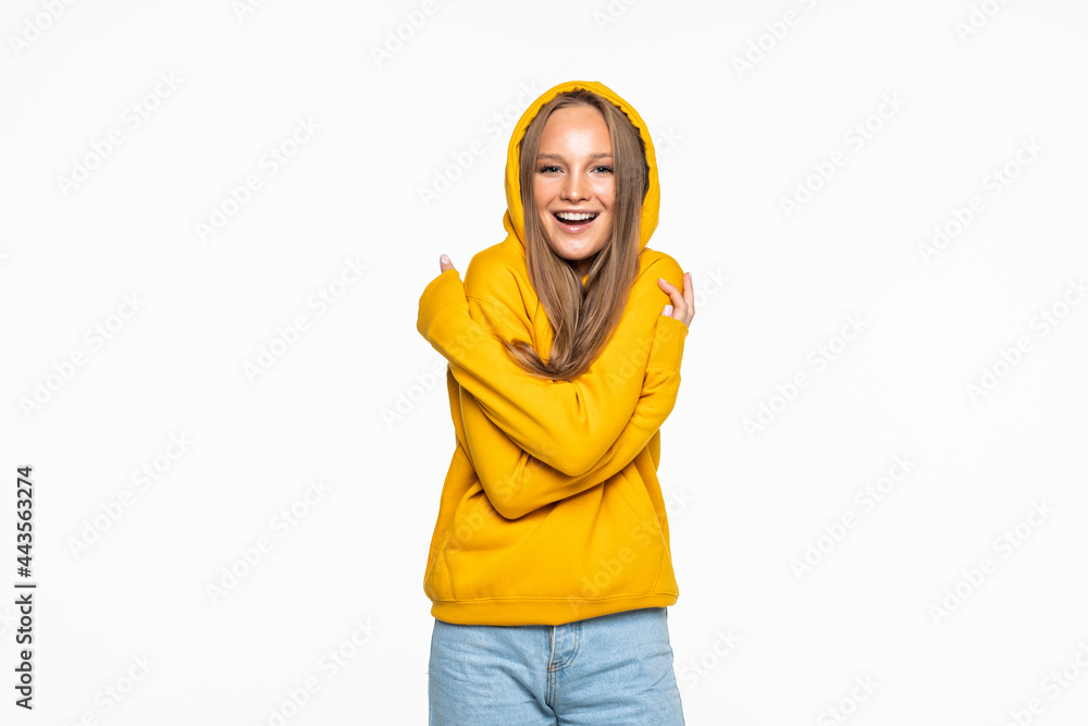Portrait of happy young woman dancing on gray background Portrait of happy young woman dancing on gray background