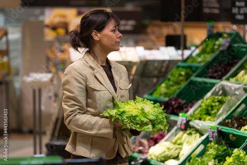 Woman Shopping Vegetables in Supermarket in Switzerland. © Mats Silvan