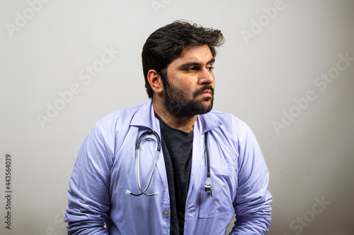 A doctor looking at one side thinking