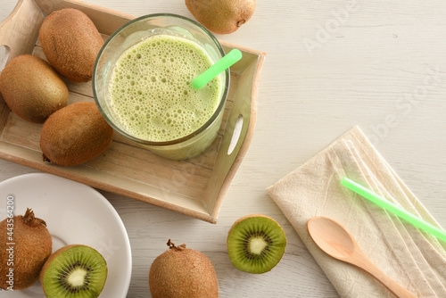 Wallpaper Mural Kiwi drink in glass on wooden tray on white wooden bench top Torontodigital.ca