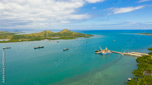 Cargo ships and tankers in the sea Harbour waiting for loading and unloading. Seaport, Tapal Wharf, Bohol, Philippines. photo