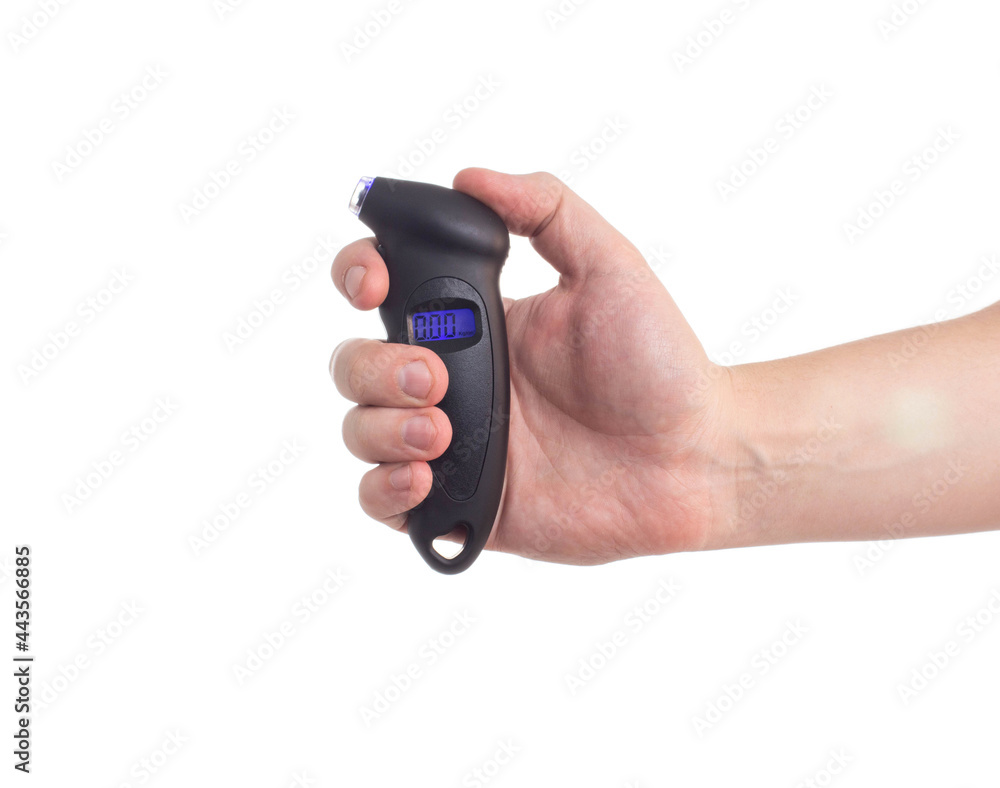Man holds in his hand a modern electronic car tire pressure gauge, white background, isolate. Diagnostic Man holds in his hand a modern electronic car tire pressure gauge, white background, isolate. Diagnostic