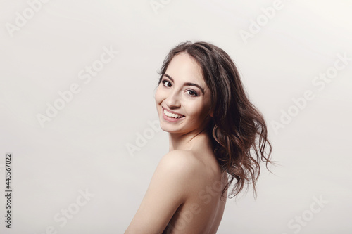 The beautiful girl is having a photo session in the studio in a night dress.