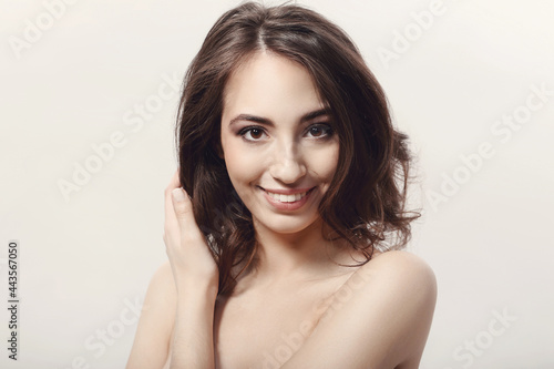 The beautiful girl is having a photo session in the studio in a night dress.