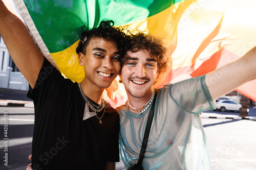 Fotografie Smiling queer men celebrating gay pride outdoors