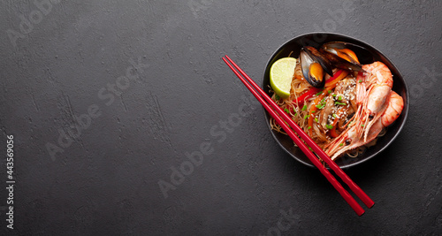 Wok with stir fried noodles, shrimps and vegetables