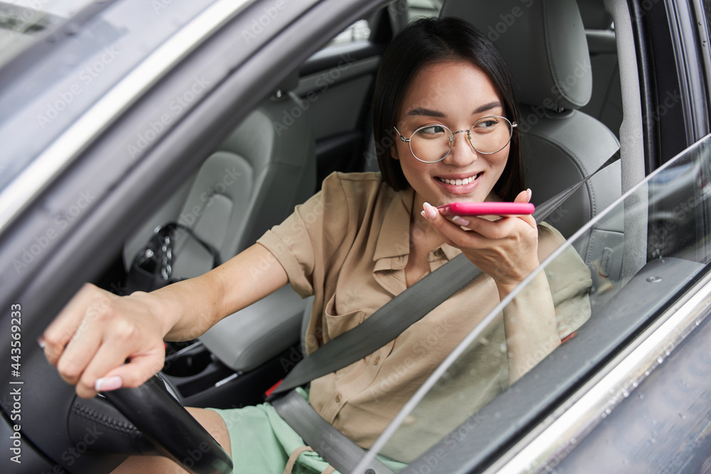 Woman is looking out of window and making phone call or recording voice message Woman is looking out of window and making phone call or recording voice message