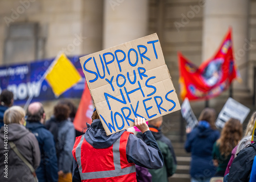 Support your NHS workers at protest rally holding home made placard sign to gain support for NHS key worker staff on march. © Matthew