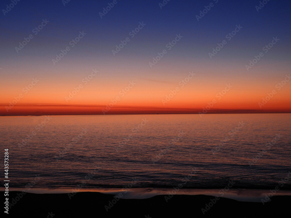 Fototapeta premium colorful sunrise over the beach at rehoboth beach, delaware, as seen from the henlopen hotel