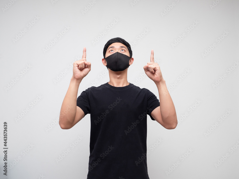 Asian man weraing mask point double finger and look up on white background Asian man weraing mask point double finger and look up on white background