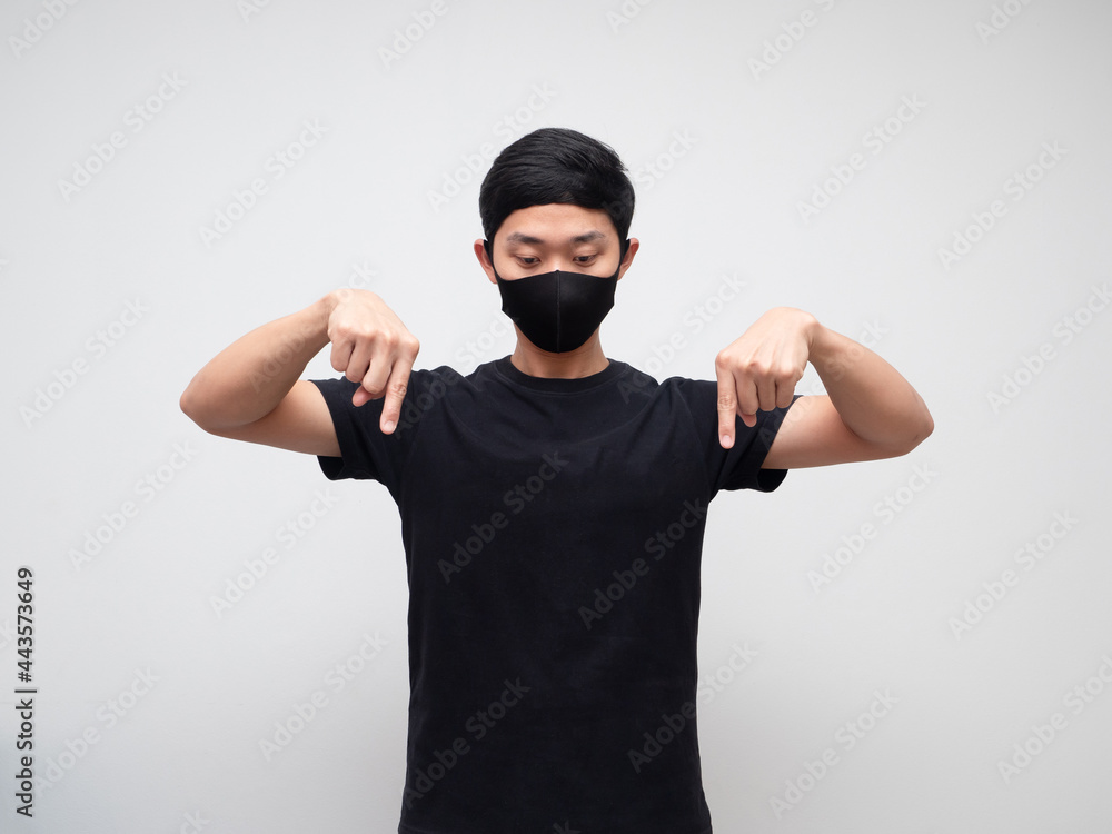 Asian man weraing mask point double finger and look down on white background Asian man weraing mask point double finger and look down on white background
