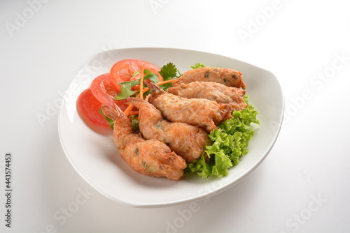 deep fried golden crispy prawn meat ball roll traditional wu Xiang with spicy sauce in white background asian halal snack menu