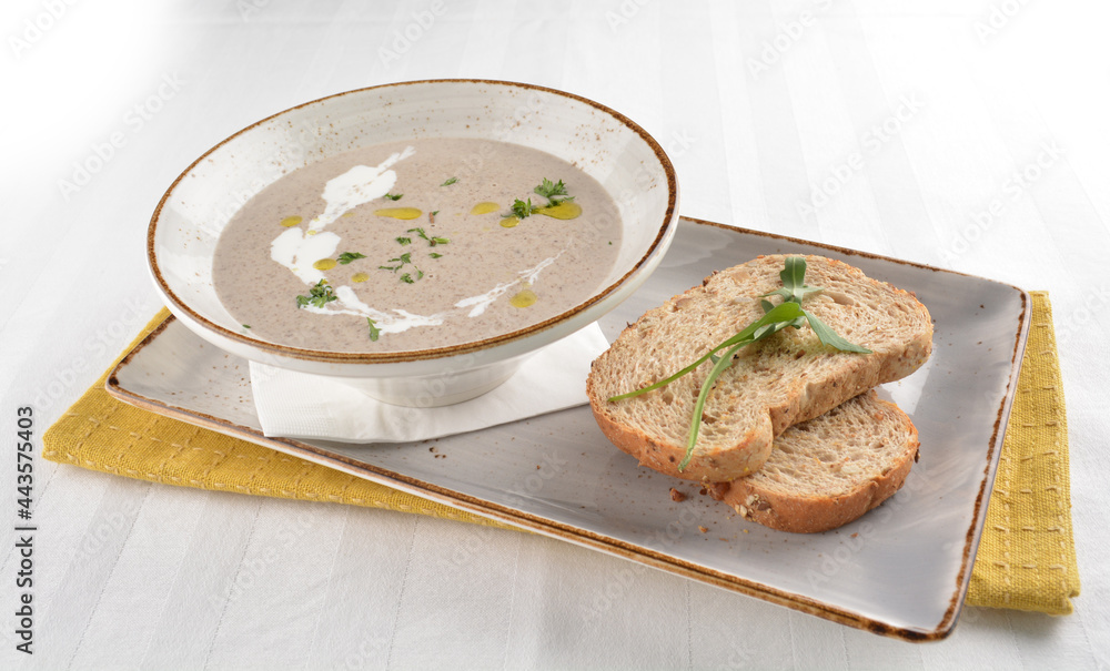 home made hot mushroom thick soup with French toast bread in white background western appetiser halal menu