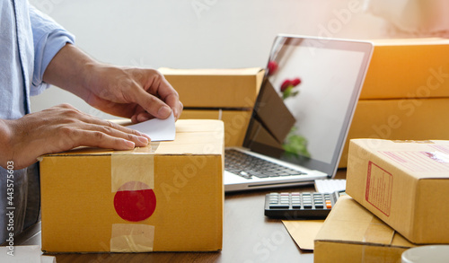 Young business man prepare parcel box of product for deliver to customer. Online selling. © witsarut