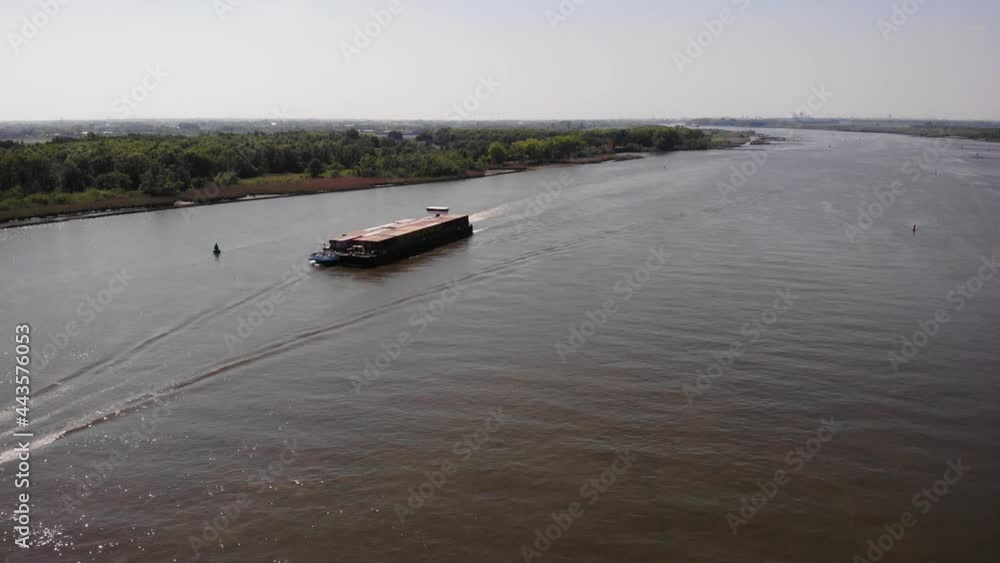 Motor Freighter Cruising On River In South Holland, Netherlands. aerial Motor Freighter Cruising On River In South Holland, Netherlands. aerial