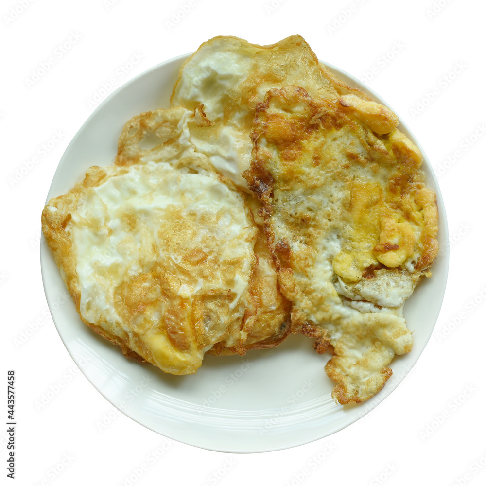 Fried eggs in a white plate on white background Fried eggs in a white plate on white background