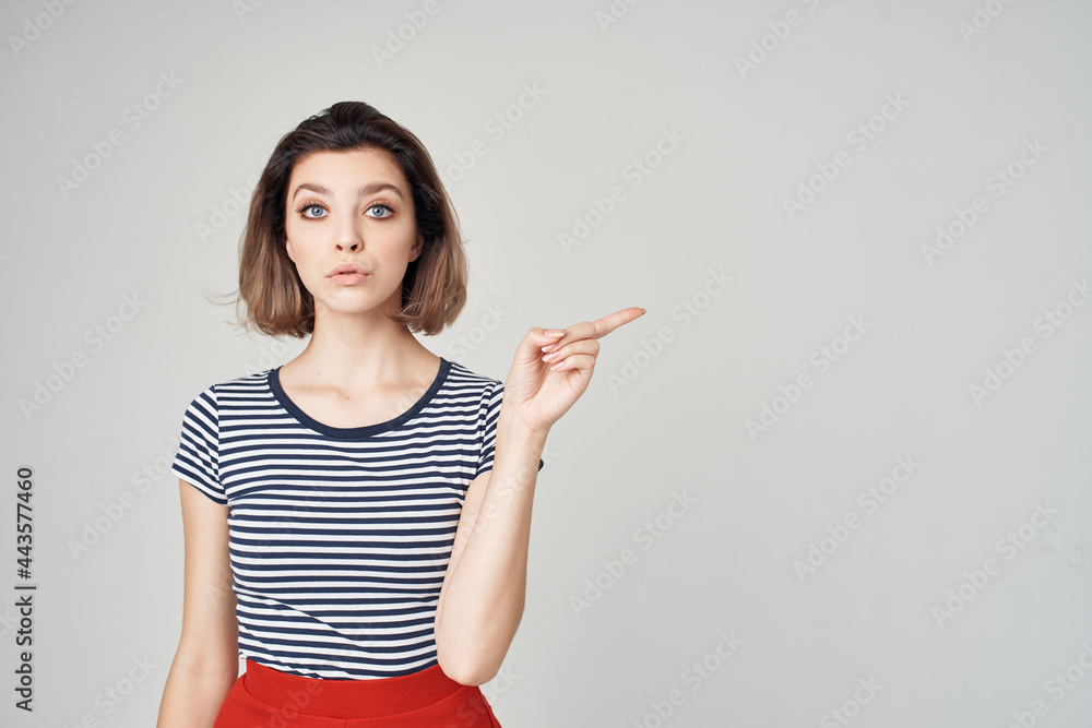 emotional blonde in a striped t-shirt gesturing with her hands emotional blonde in a striped t-shirt gesturing with her hands