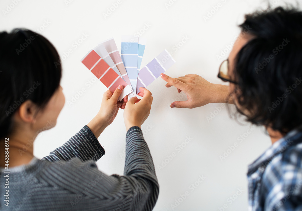 Asian couple choosing wall color Asian couple choosing wall color