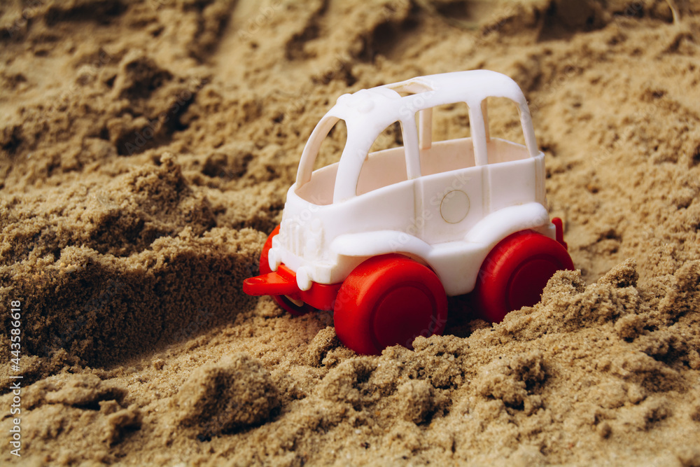 Small white car rides on the sand Small white car rides on the sand