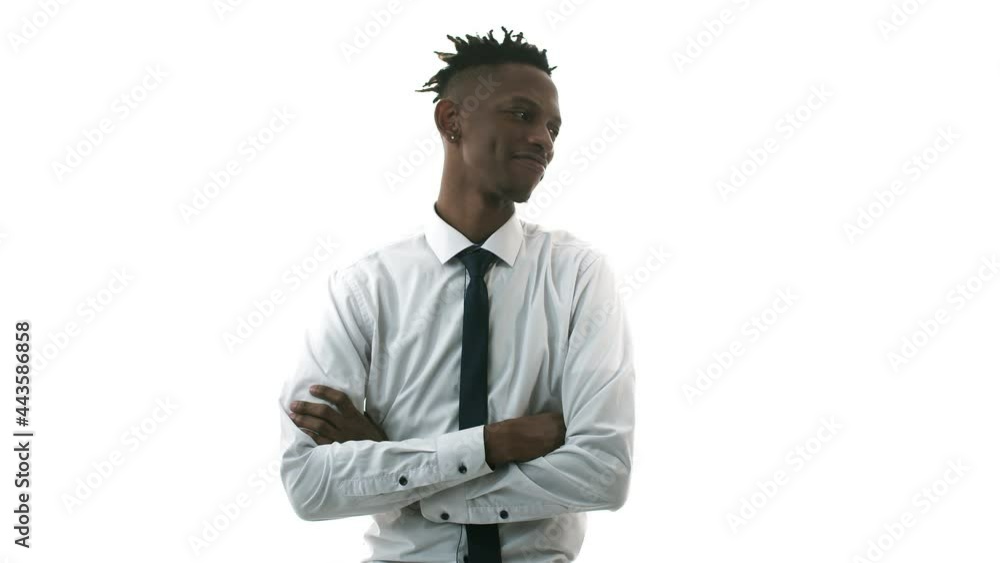 Black man in shirt and tie stands against white background, shakes his head and smiles, crossing his arms over his chest. Office concept Black man in shirt and tie stands against white background, shakes his head and smiles, crossing his arms over his chest. Office concept
