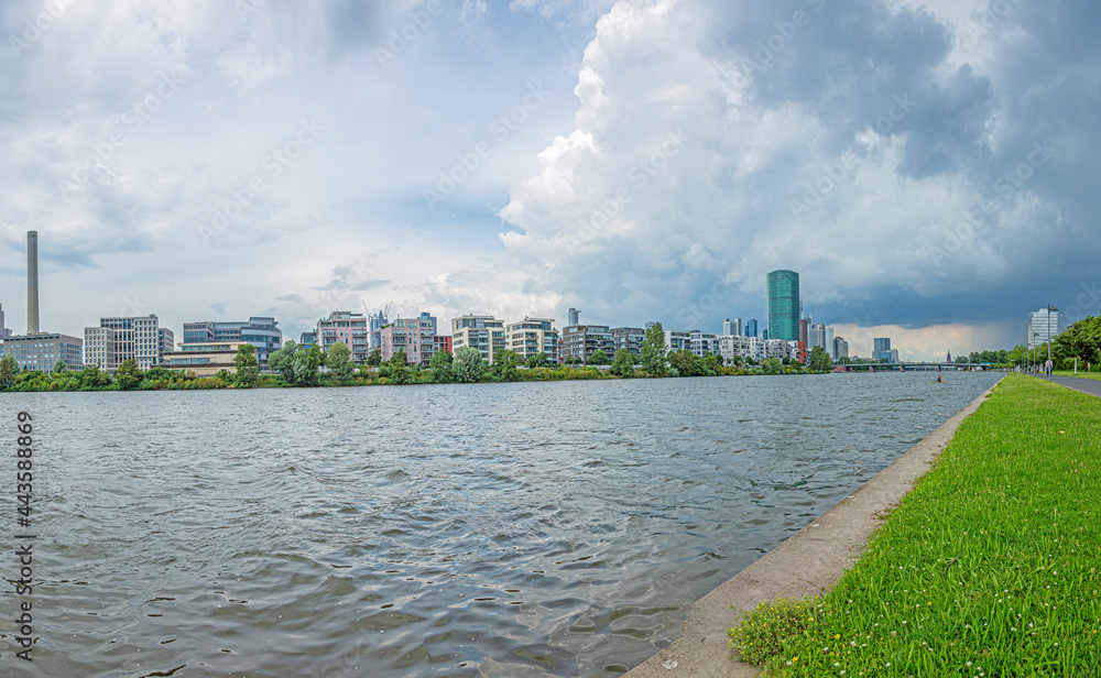 View of the Frankfurt skyline from the banks of the Main River during an approaching thunderstorm