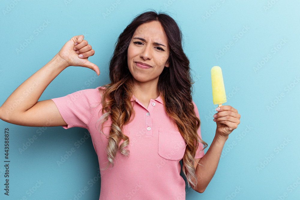 Young latin woman holding ice cream isolated on blue background feels proud and self confident, example to follow. Young latin woman holding ice cream isolated on blue background feels proud and self confident, example to follow.